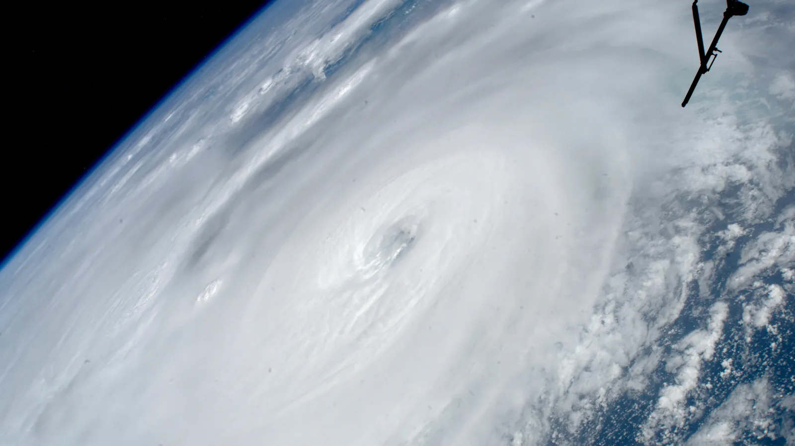 Hurricane Ian filling the frame from orbit, its eye and spiral rainbands lit by daylight against the curve of the Earth, photographed from the International Space Station on 28 September 2022.